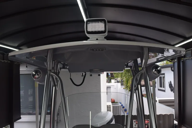 Slide: The Image of 2022 Aquasport 2300 Center Console boat with T-top and mounted spotlight. - 57