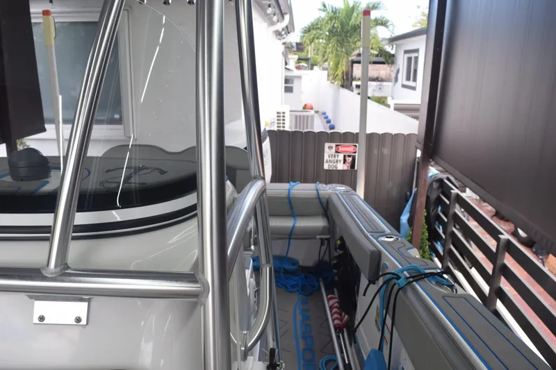 Slide: The Image of 2022 Aquasport 2300 Center Console boat docked in a residential area. - 61