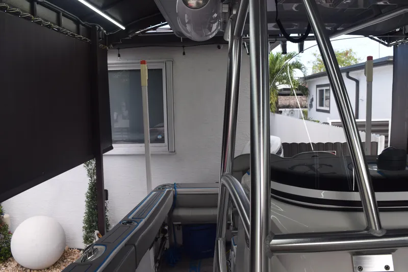 Slide: The Image of 2022 Aquasport 2300 Center Console boat in a covered outdoor area. - 64