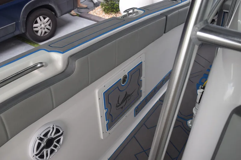 Slide: The Image of 2022 Aquasport 2300 Center Console interior with speaker and storage compartment. - 66