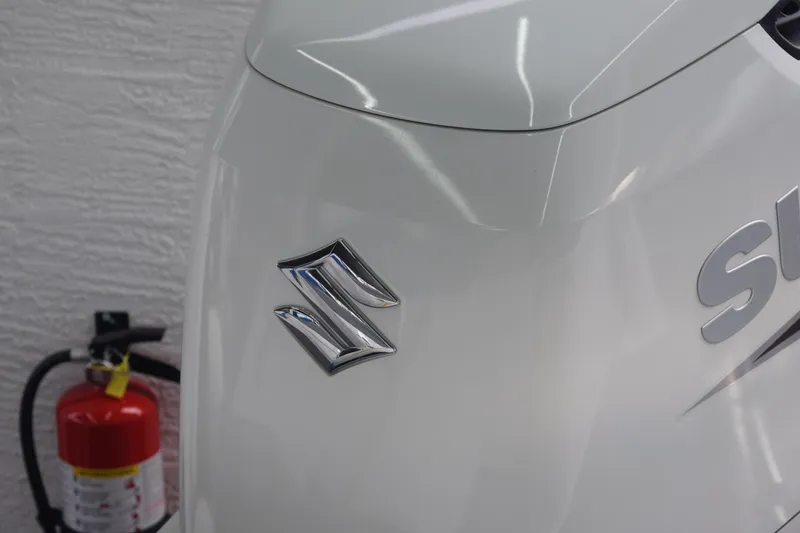 Slide: The Image of 2022 Aquasport 2300 Center Console with Suzuki engine logo and fire extinguisher. - 69