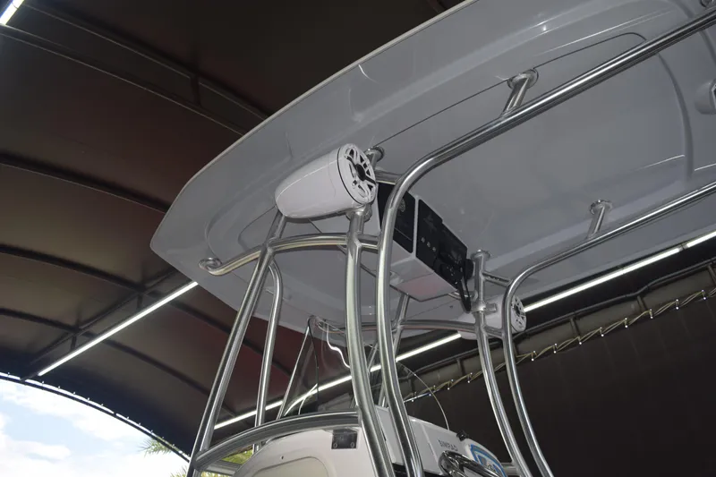 Slide: The Image of 2022 Aquasport 2300 Center Console boat with T-top and mounted speakers. - 72