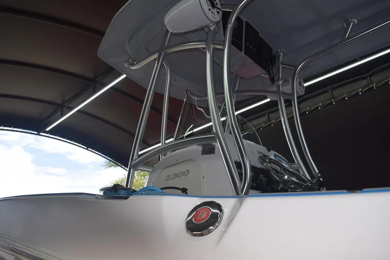Slide: The Image of 2022 Aquasport 2300 Center Console boat under a canopy, showcasing sleek design. - 74