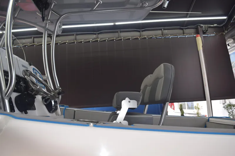 Slide: The Image of 2022 Aquasport 2300 Center Console interior with steering wheel and seating. - 78