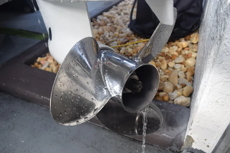 Slide: The Image of Close-up of a wet propeller on a 2022 Aquasport 2300 Center Console boat. - 81