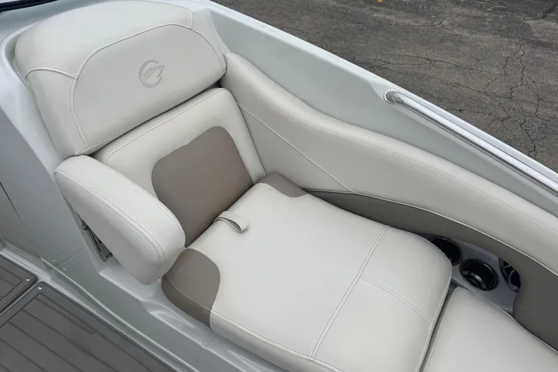 Slide: The Image of 2019 Crownline 275 SS boat seat with beige and white upholstery, featuring cup holders. - 14