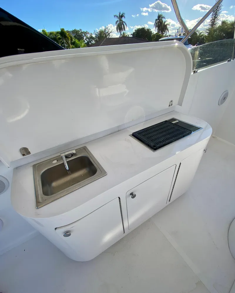 Slide: The Image of 2007 Rodriquez 80 Widebody yacht kitchenette with sink and grill, outdoor setting. - 15