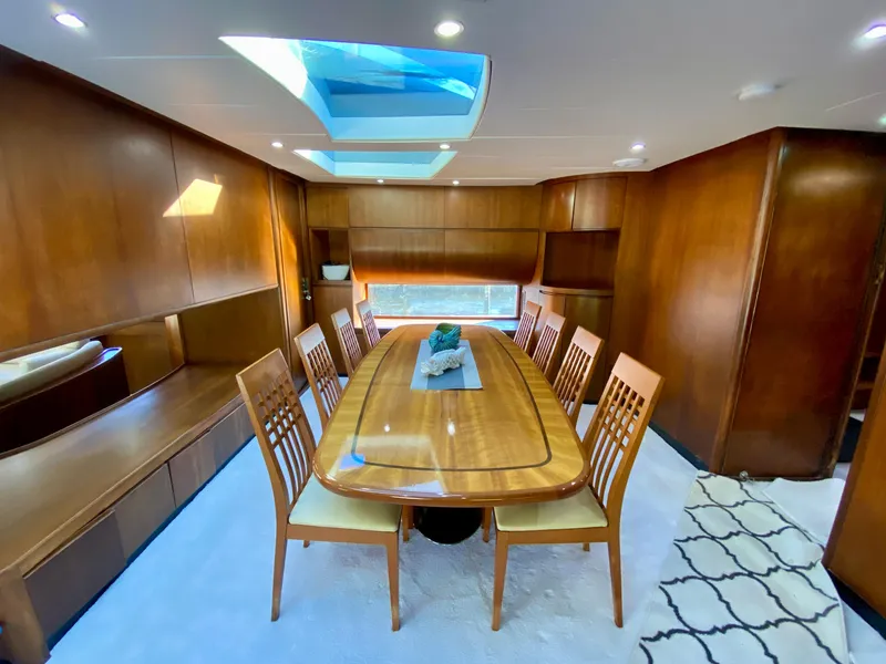 Slide: The Image of Luxurious dining area on 2007 Rodriquez 80 Widebody yacht with wooden table and skylight. - 29