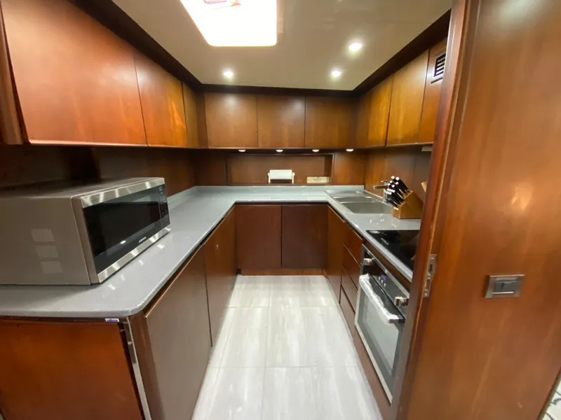 Slide: The Image of Luxurious kitchen in 2007 Rodriquez 80 Widebody yacht with modern appliances and wood cabinetry. - 34