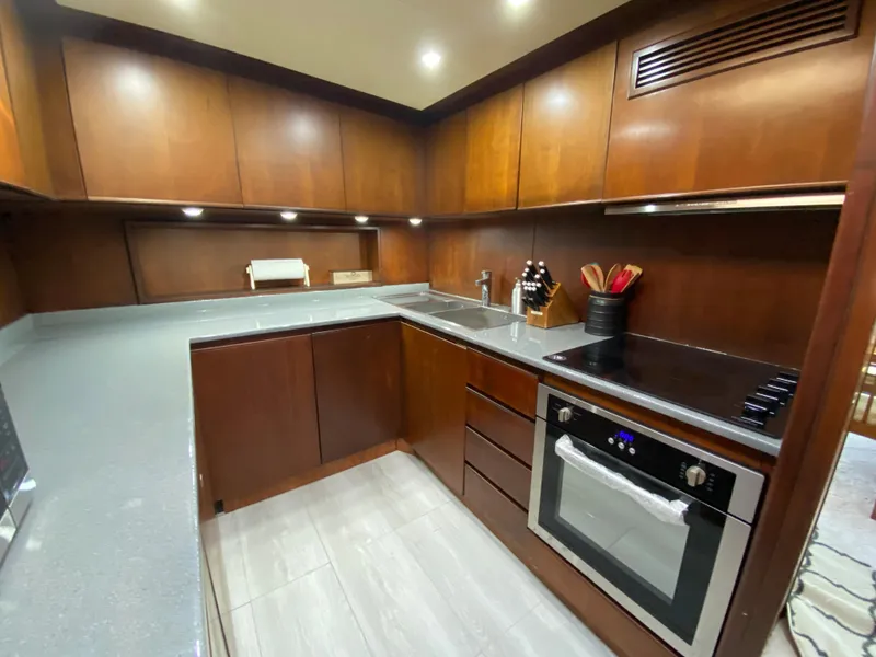 Slide: The Image of Luxurious kitchen in 2007 Rodriquez 80 Widebody yacht with modern appliances and wood cabinetry. - 36