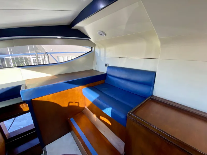 Slide: The Image of Interior of 2007 Rodriquez 80 Widebody yacht with blue seating and wooden accents. - 43