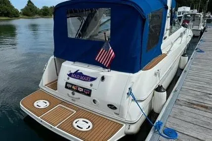 Slide: The Image of 1996 Sea Ray 290 Sundancer boat interior with white seating and wooden flooring. - 4