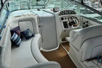Slide: The Image of 1996 Sea Ray 290 Sundancer helm with Garmin navigation and wood-accented steering wheel. - 5
