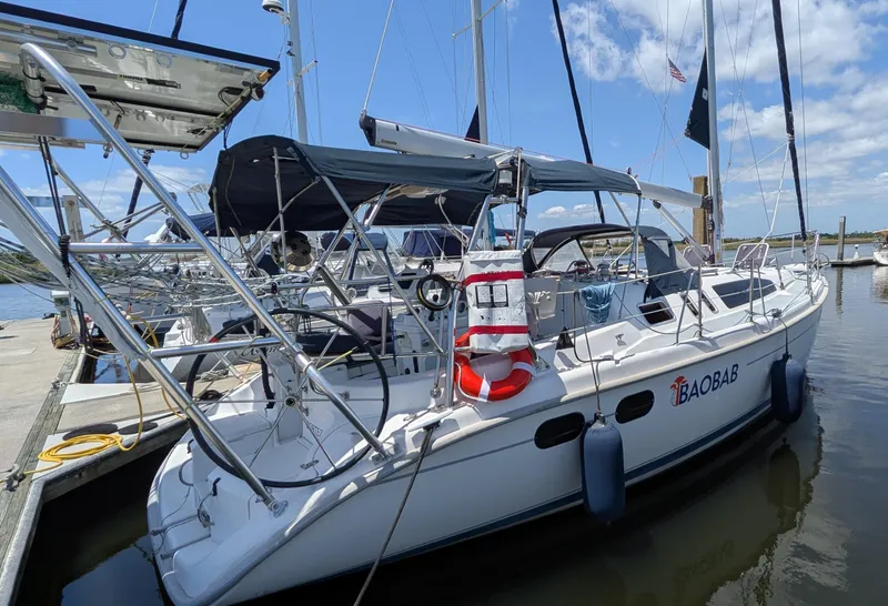 Slide: The Image of Sailboat Hunter 380, 2001 model, docked at marina under clear blue sky. - 1