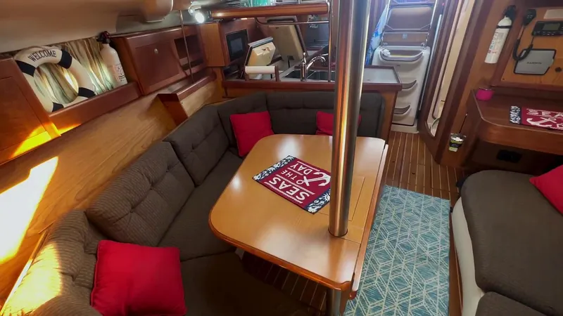 Slide: The Image of Cozy interior of 2001 Hunter 380 sailboat with dining area and nautical decor. - 14