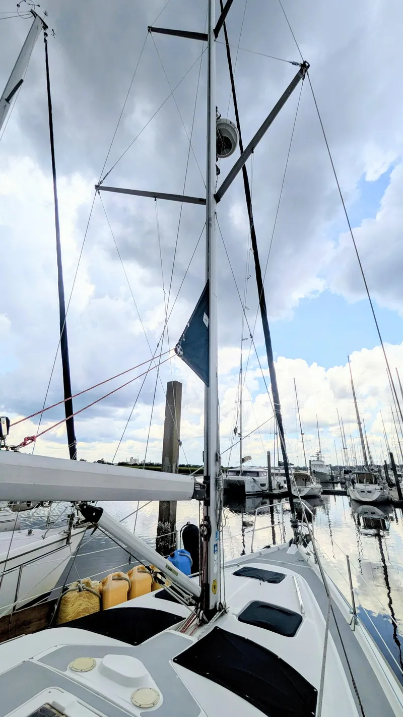 Slide: The Image of Sailboat Hunter 380, 2001 model, docked at marina under cloudy sky. - 4