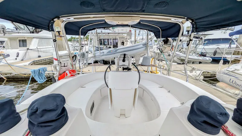 Slide: The Image of Cockpit view of a 2001 Hunter 380 sailboat docked at a marina. - 8