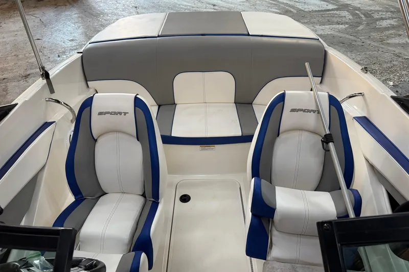 Slide: The Image of 2012 Sea Ray 190 Sport boat interior with blue and white seating. - 11