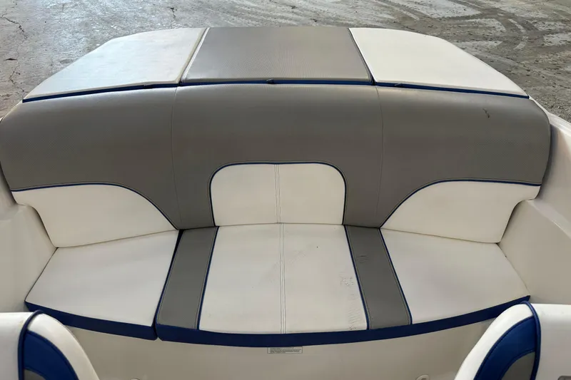 Slide: The Image of 2012 Sea Ray 190 Sport boat seating with gray and white upholstery. - 4