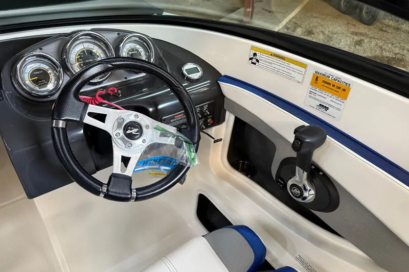 Slide: The Image of 2012 Sea Ray 190 Sport dashboard with steering wheel and control panel. - 6