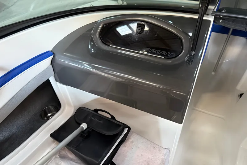 Slide: The Image of Interior of a 2012 Sea Ray 190 Sport boat, featuring storage compartment and accessories. - 7