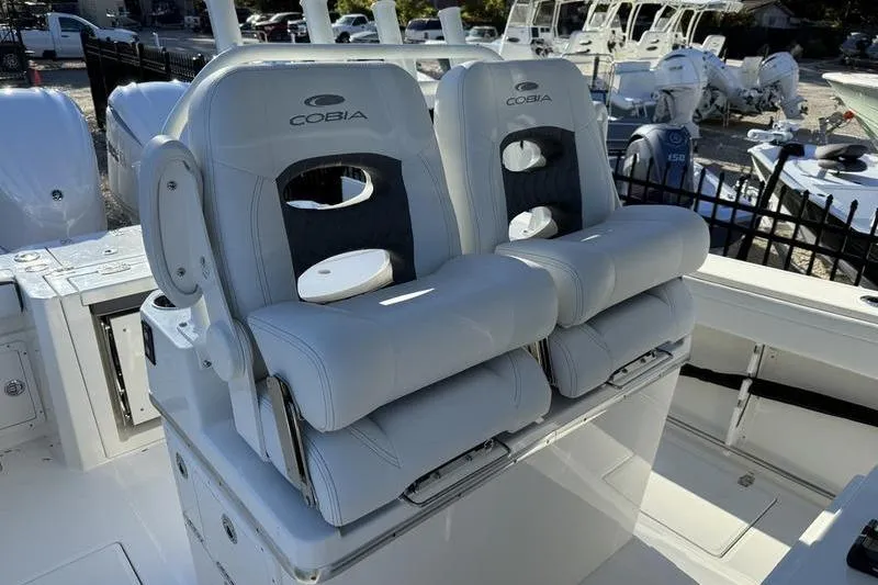 Slide: The Image of 2026 Cobia 265 Open Center Console boat with dual cushioned seats. - 13