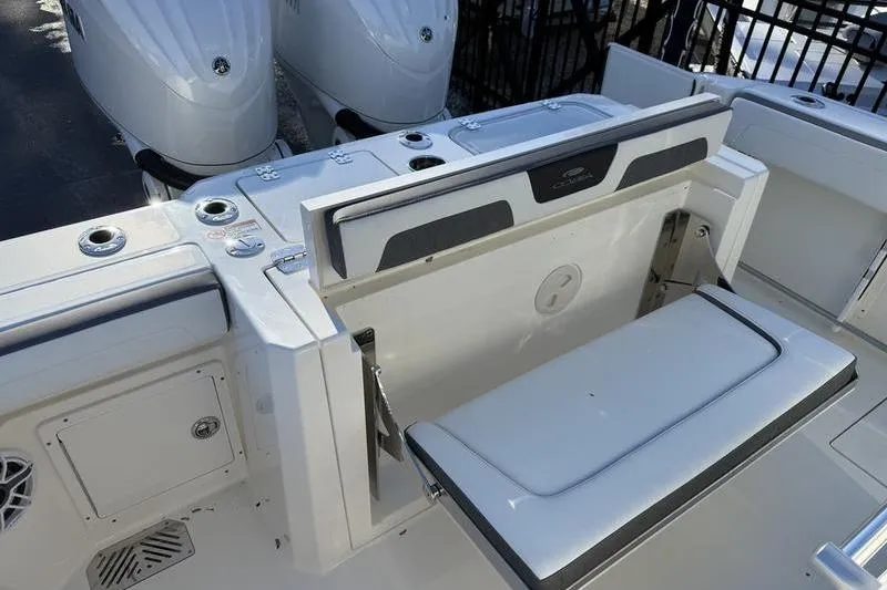 Slide: The Image of 2026 Cobia 265 Open Center Console boat with foldable seating and dual engines. - 19