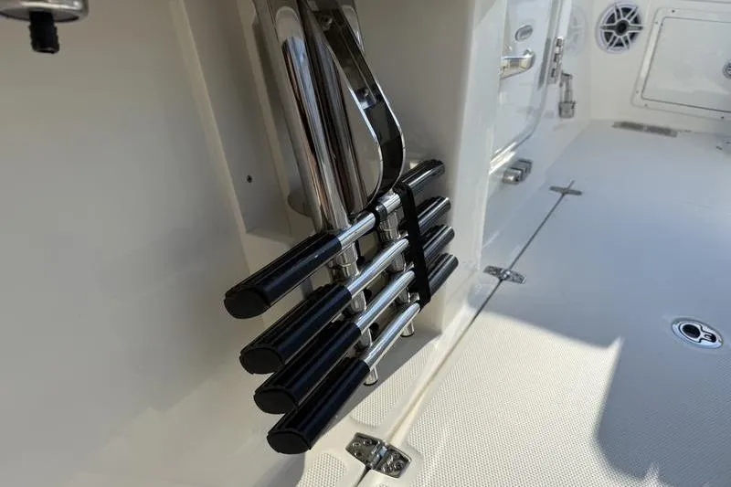 Slide: The Image of 2026 Cobia 265 Open Center Console boat interior with rod holders. - 21
