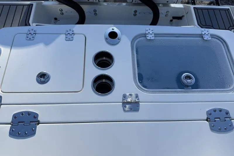 Slide: The Image of 2026 Cobia 265 Open Center Console boat deck with storage compartments. - 22