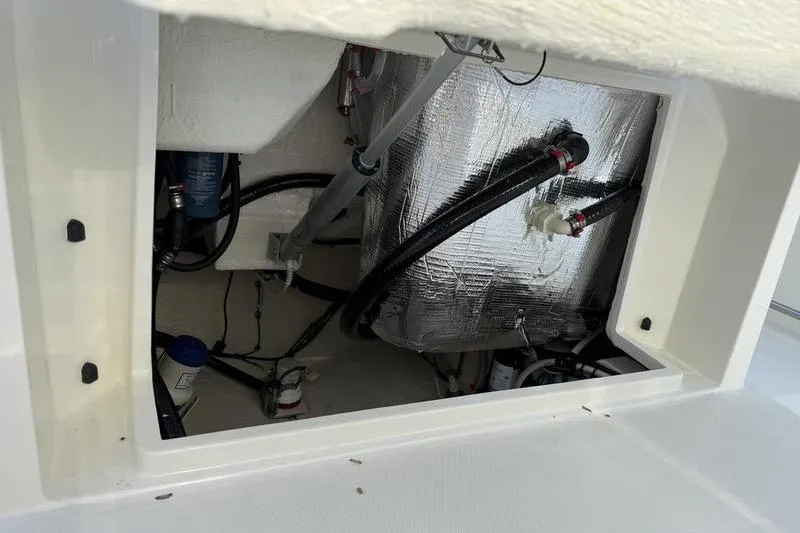 Slide: The Image of 2026 Cobia 265 Open Center Console boat interior wiring and plumbing details. - 24