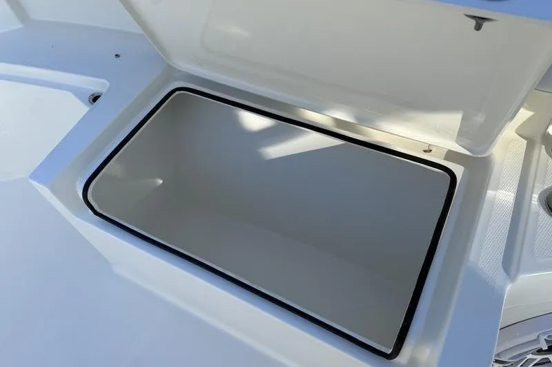 Slide: The Image of Open storage compartment on 2026 Cobia 265 Open Center Console boat. - 27