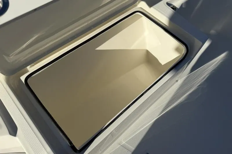 Slide: The Image of Open storage compartment on 2026 Cobia 265 Open Center Console boat. - 28