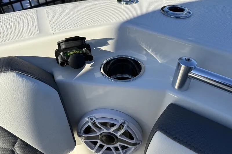 Slide: The Image of 2026 Cobia 265 Open Center Console boat interior with speaker and cup holder. - 30