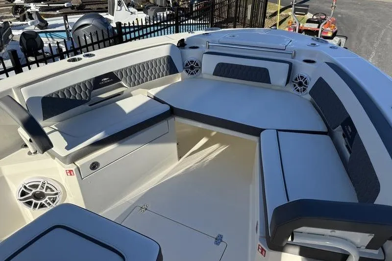 Slide: The Image of 2026 Cobia 265 Open Center Console boat interior with cushioned seating and speakers. - 5