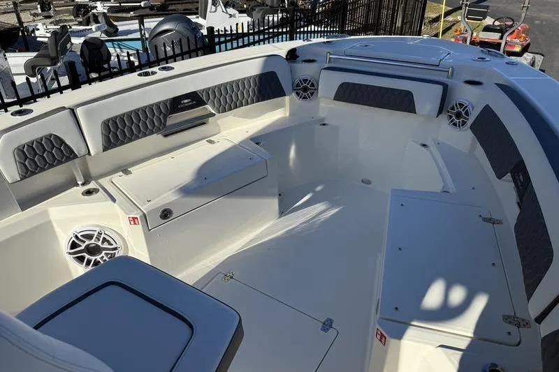 Slide: The Image of 2026 Cobia 265 Open Center Console boat interior with seating and storage compartments. - 7