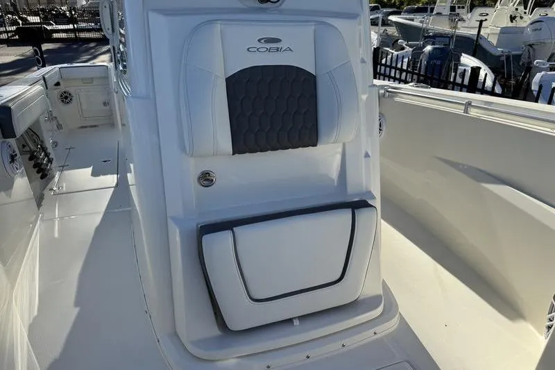 Slide: The Image of 2026 Cobia 265 Open Center Console boat interior with seating and storage. - 9