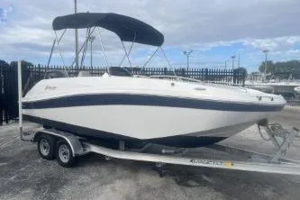 Slide: The Image of 2022 Hurricane SunDeck Sport 192 RL OB boat on trailer, parked outdoors. - 3