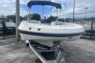 Slide: The Image of 2022 Hurricane SunDeck Sport 192 RL OB boat on trailer, parked outdoors. - 4