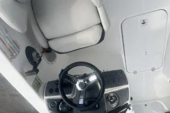 Slide: The Image of 2022 Hurricane SunDeck Sport 192 RL OB boat interior with steering wheel and seating. - 8