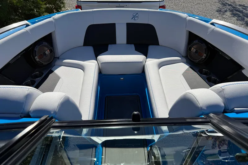 Slide: The Image of 2019 MasterCraft X24 boat interior with white seating and speakers. - 8