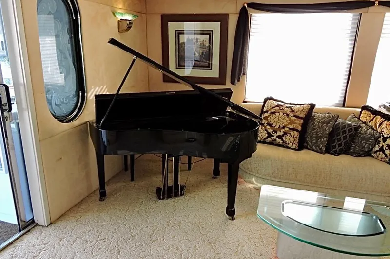 Slide: The Image of Luxurious yacht interior with grand piano, elegant sofa, and decorative pillows. - 10
