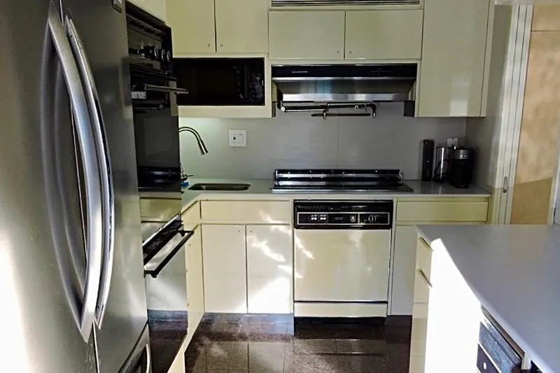 Slide: The Image of Modern kitchen interior on a 1992 Christensen Motor Yacht, featuring stainless steel appliances. - 14