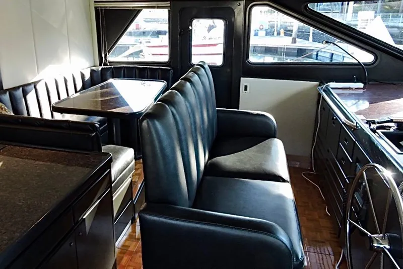 Slide: The Image of Luxurious 1992 Christensen motor yacht interior with leather seating and dining area. - 15