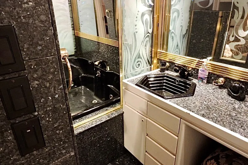Slide: The Image of Luxurious bathroom on 1992 Christensen Motor Yacht with black sink and elegant decor. - 19