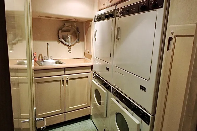 Slide: The Image of Laundry room on 1992 Christensen Motor Yacht with washer, dryer, sink, and storage cabinets. - 25