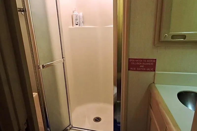 Slide: The Image of Christensen 1992 motor yacht deck with wooden flooring and sleek white exterior. - 29