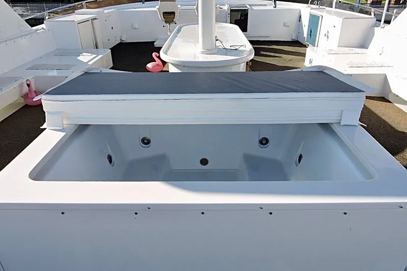 Slide: The Image of Christensen 1992 motor yacht deck with pink flamingo inflatables in a pool. - 38