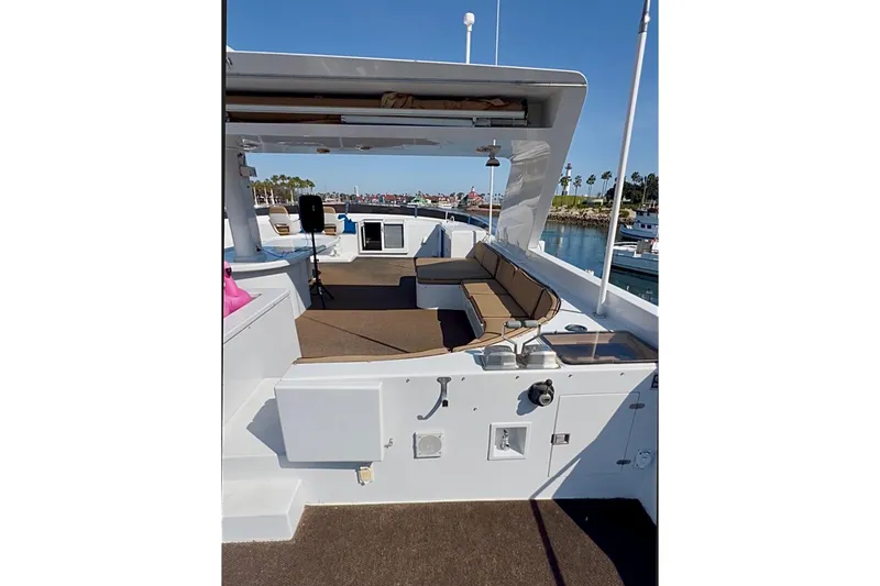 Slide: The Image of Outdoor seating on a 1992 Christensen motor yacht, surrounded by palm trees and cityscape. - 41