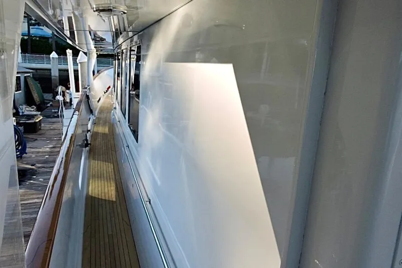 Slide: The Image of Side deck view of 1992 Christensen Motor Yacht with wooden flooring and sleek white exterior. - 45