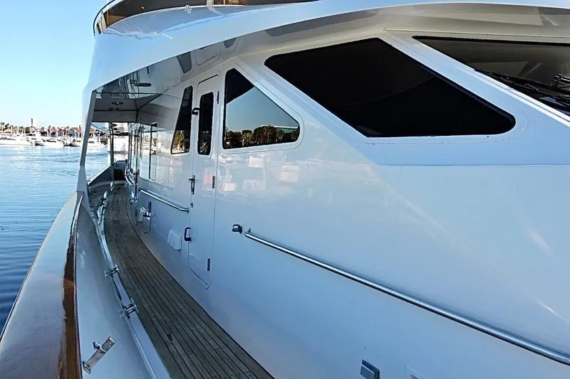 Slide: The Image of Side view of 1992 Christensen Motor Yacht with wooden deck and reflective windows. - 46